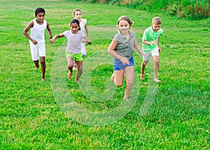 Group of children having fun together outdoors running