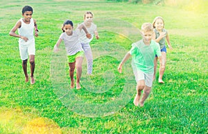 Group of children having fun together outdoors running