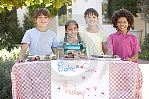 Group Of Children Holding Bake Sale