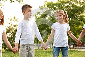 Group of children holding hands together in park