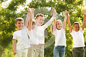 Group of children holding hands up. Volunteer project