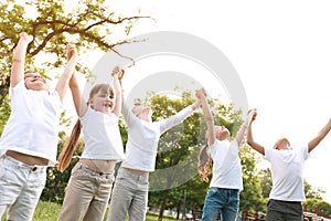 Group of children holding hands up. Volunteer project