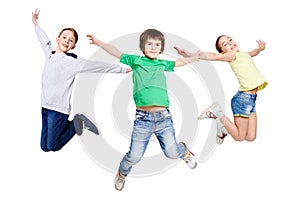 Group of children jumping at white isolated studio background