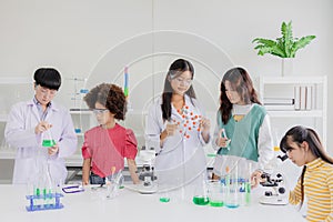 Group of children kids teen playing in science chemical lab for learning education in school