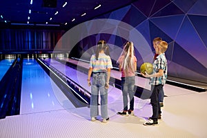 Group of children on the lane in bowling alley