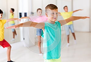 Group children learn dance movements in class