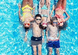 Group of children ln in swimming pool from above