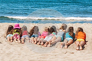 Group of children lying on the beach