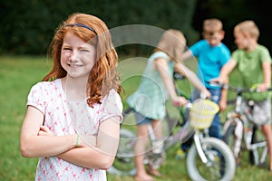 Group Of Children Outdoors Playing On Bikes