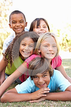 Group Of Children Piled Up In Park photo