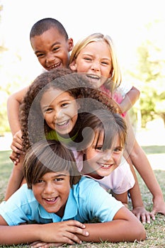 Group Of Children Piled Up In Park photo