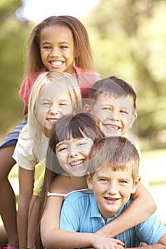 Group Of Children Piled Up In Park photo