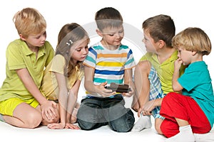 Group children plaing with a new gadget