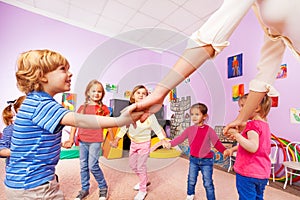 Group of children play roundelay view from bellow