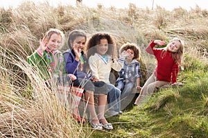 Group Of Children Playing In Field Together