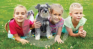 Group of children playing on green grass in spring park