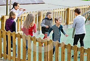 Group of children playing romp game Touch-last outdoors