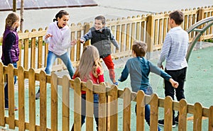 Group of children playing romp game Touch-last outdoors photo