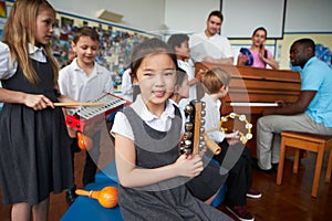 Group Of Children Playing In School Orchestra Together