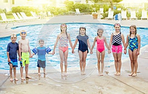 Group of Children playing together at the swimming pool