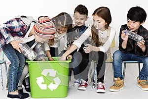 Group of children with a recycling symbol