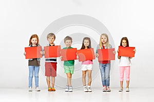 Group of children with red banners isolated in white