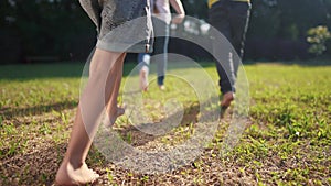 a group of children run in the park on the grass. happy family kid dream concept. children with bare feet run on the