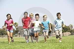 Group Of Children Running In Park