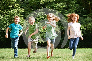 Group Of Children Running Towards Camera In Playground