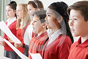 Group Of Children Singing In School Choir