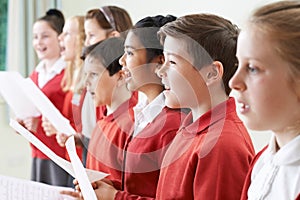 Group Of Children Singing In School Choir