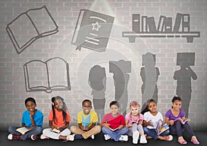 Group of children sitting in front of book reading silhouette graphics