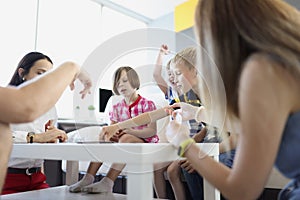 Group of children spend time in kindergarten with teacher or mum entertain kids