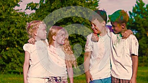 Group of children standing in couples, looking at each other intently and smiling at the camera