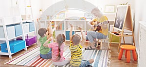 Group of children and teacher in the music class