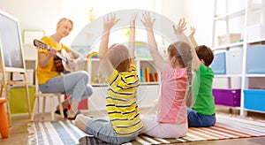 Group of children and teacher in the music class