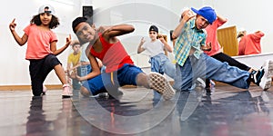 Group of children training hip hop movements in dance class