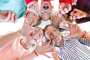 Group Of Children of Various Ages Standing in Circle, Looking Down Into Camera.