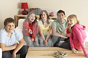 Group Of Children Watching TV At Home