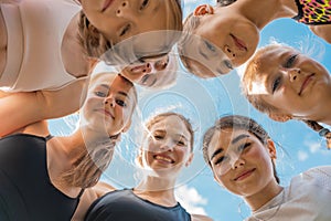 Group of children and young girls with female coach