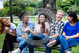 Group of chilling multi ethnic young adult people