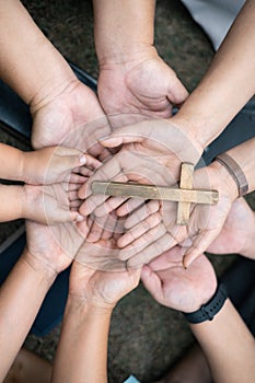 Group of Christian believers clasped hands in prayer, In the church, expressing their faith through worship and reverence for God