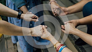 Group of christian are holding hands and pray together outdoor