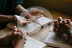 Group of christian people reading and study bible in home and pray together.