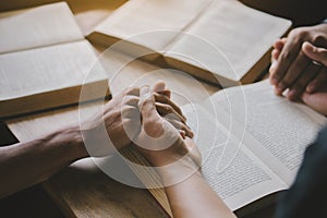 Group of christian people reading and study bible in home and pray together.