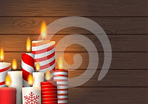 Group of Christmas burning candles on wood