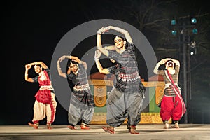 Group of Classical Odissi dancers performing Odissi Dance on stage at Konark Temple, Odisha, India.