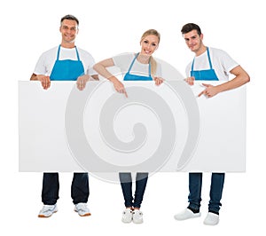 Cleaners Holding Blank Billboard