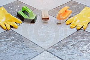 Group of cleaning equipment placed on a wet tiled floor