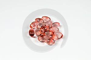 Group of clear red soft gelatine capsules.